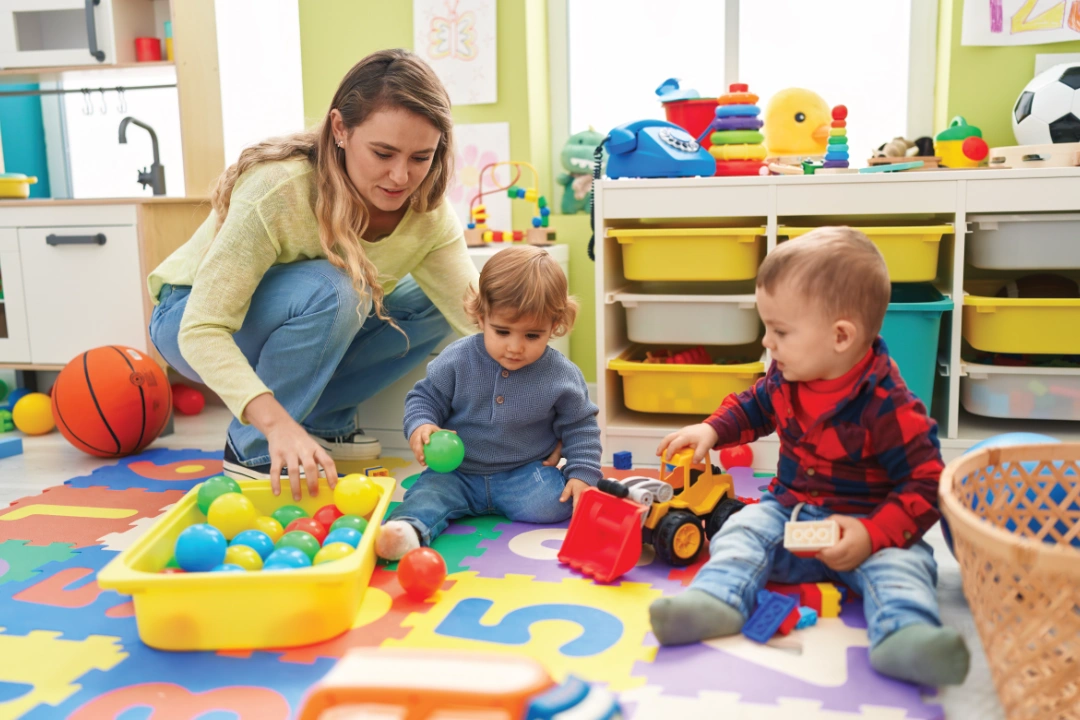 Children playing with toys in nursery room